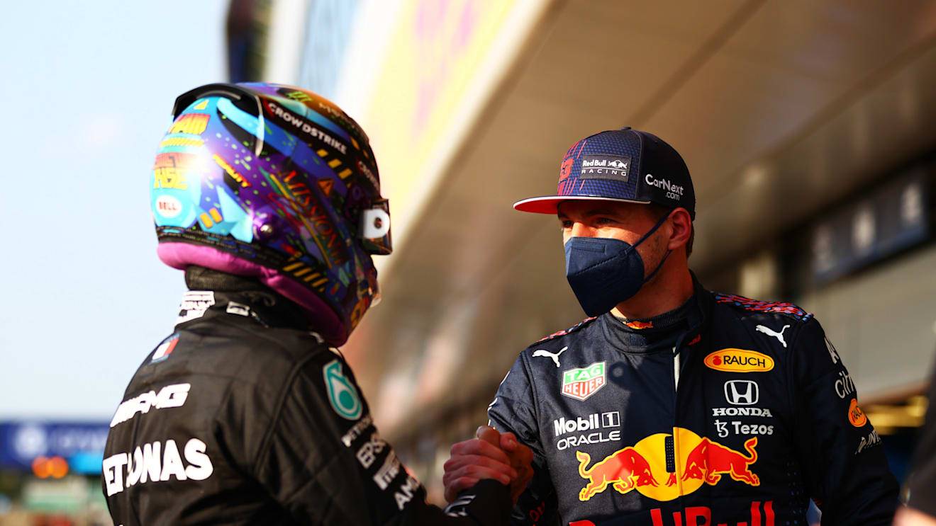 NORTHAMPTON, ENGLAND - JULY 16: Fastest qualifier Lewis Hamilton of Great Britain and Mercedes GP and second fastest qualifier Max Verstappen of Netherlands and Red Bull Racing shake hands in parc ferme during qualifying ahead of the F1 Grand Prix of Great Britain at Silverstone on July 16, 2021 in Northampton, England. (Photo by Dan Istitene - Formula 1/Formula 1 via Getty Images)
