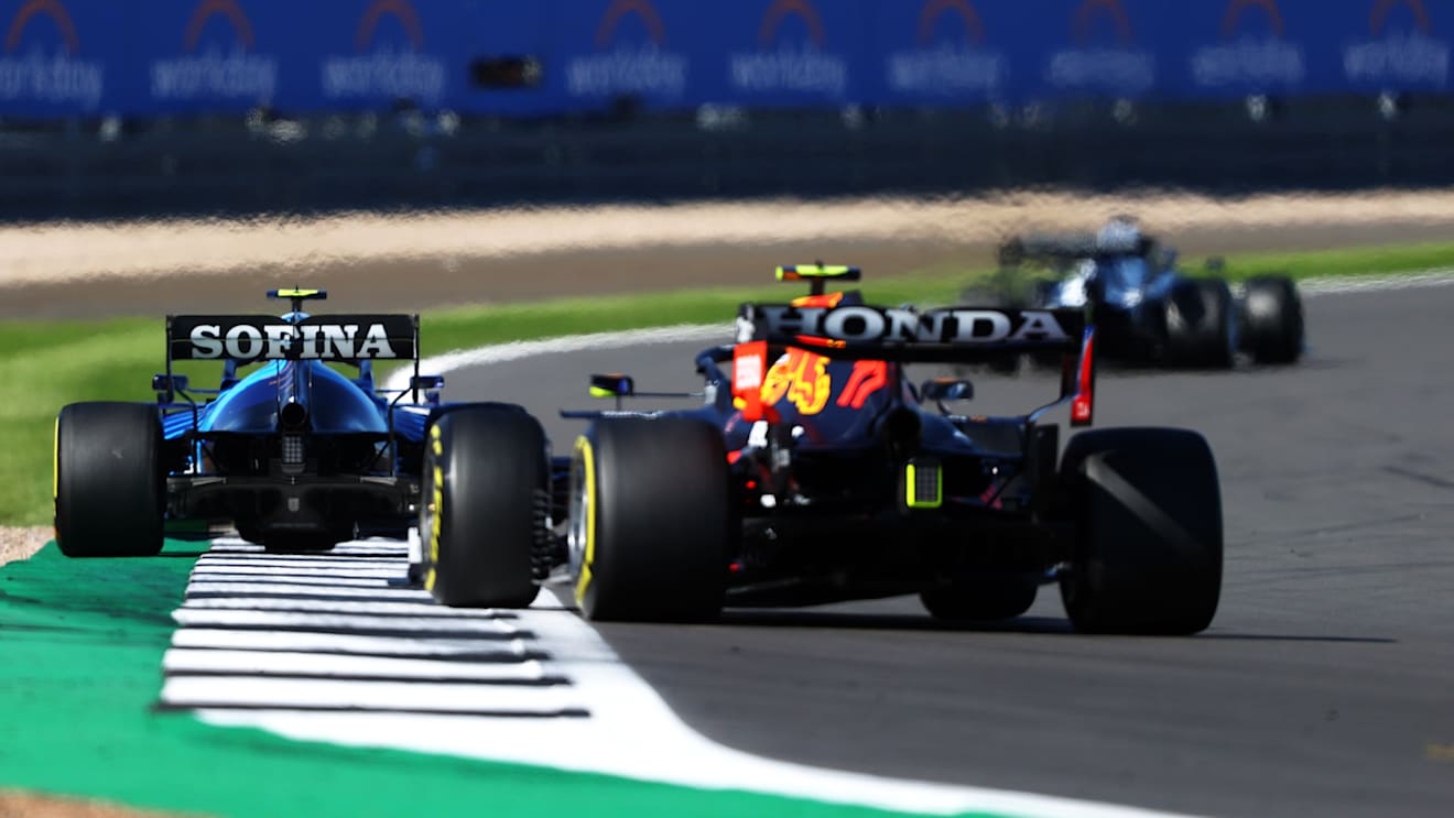 NORTHAMPTON, ENGLAND - JULY 17: Nicholas Latifi of Canada driving the (6) Williams Racing FW43B Mercedes leads Sergio Perez of Mexico driving the (11) Red Bull Racing RB16B Honda during the Sprint for the F1 Grand Prix of Great Britain at Silverstone on July 17, 2021 in Northampton, England. (Photo by Bryn Lennon - Formula 1/Formula 1 via Getty Images)