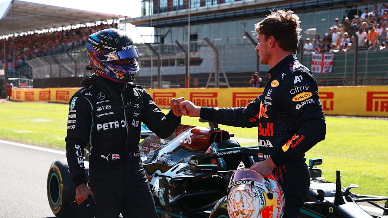 NORTHAMPTON, ENGLAND - JULY 17: Winner Max Verstappen of Netherlands and Red Bull Racing and second placed Lewis Hamilton of Great Britain and Mercedes GP bump fists in parc ferme during the Sprint for the F1 Grand Prix of Great Britain at Silverstone on July 17, 2021 in Northampton, England. (Photo by Mark Thompson/Getty Images)