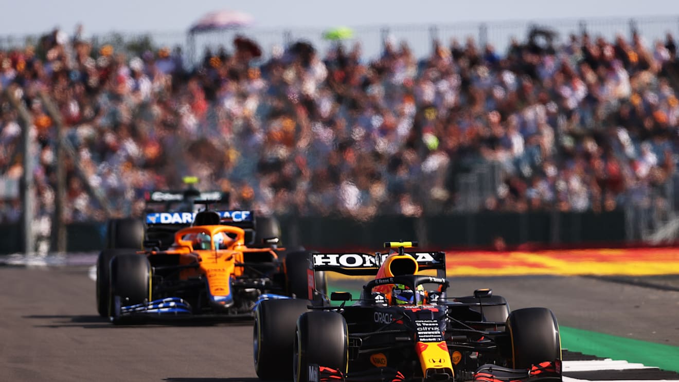 NORTHAMPTON, ENGLAND - JULY 17: Sergio Perez of Mexico driving the (11) Red Bull Racing RB16B Honda leads Daniel Ricciardo of Australia driving the (3) McLaren F1 Team MCL35M Mercedes during the Sprint for the F1 Grand Prix of Great Britain at Silverstone on July 17, 2021 in Northampton, England. (Photo by Lars Baron/Getty Images)