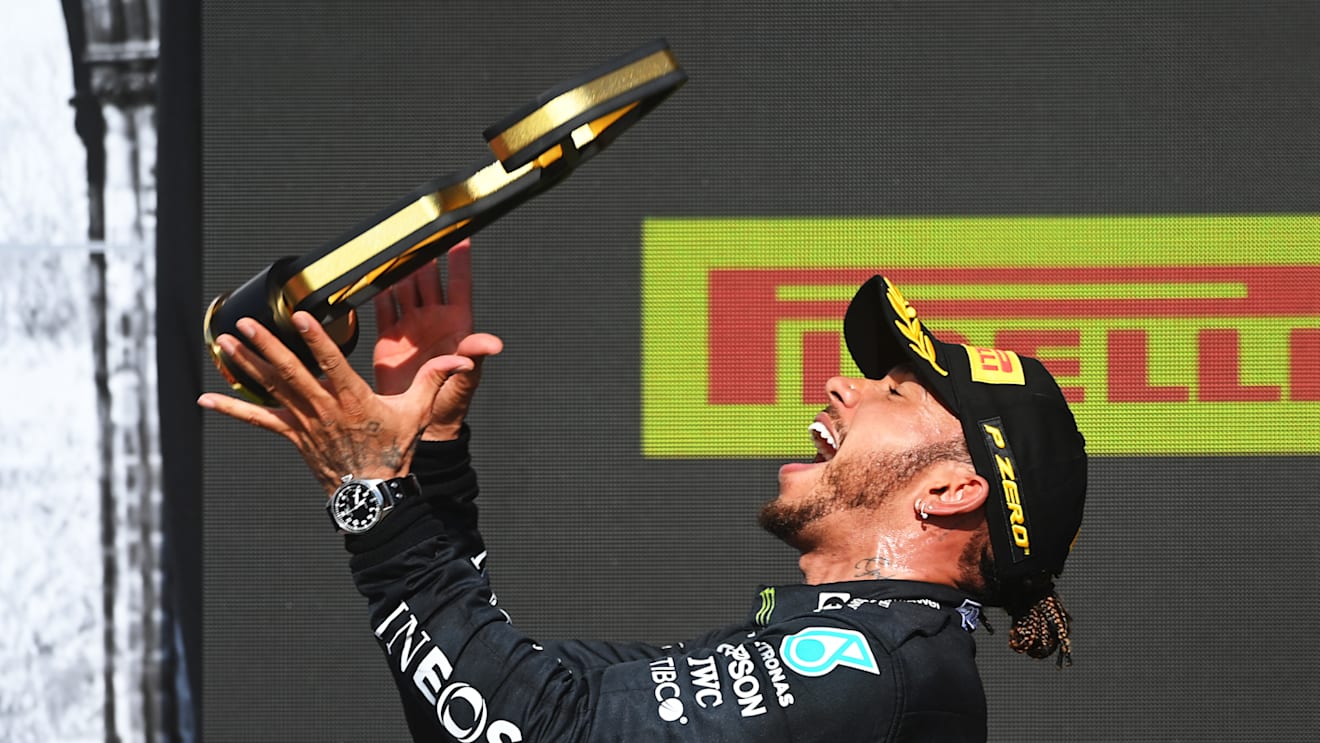 NORTHAMPTON, ENGLAND - JULY 18: Race winner Lewis Hamilton of Great Britain and Mercedes GP celebrates on the podium during the F1 Grand Prix of Great Britain at Silverstone on July 18, 2021 in Northampton, England. (Photo by Michael Regan/Getty Images)
