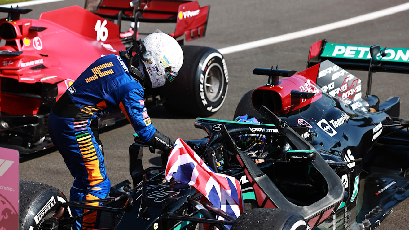 NORTHAMPTON, ENGLAND - JULY 18: Race winner Lewis Hamilton of Great Britain and Mercedes GP is congratulated by Lando Norris of Great Britain and McLaren F1 in parc ferme during the F1 Grand Prix of Great Britain at Silverstone on July 18, 2021 in Northampton, England. (Photo by Mark Thompson/Getty Images)