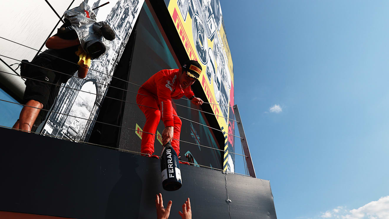 NORTHAMPTON, ENGLAND - JULY 18: Second placed Charles Leclerc of Monaco and Ferrari celebrates on the podium  during the F1 Grand Prix of Great Britain at Silverstone on July 18, 2021 in Northampton, England. (Photo by Mark Thompson/Getty Images)