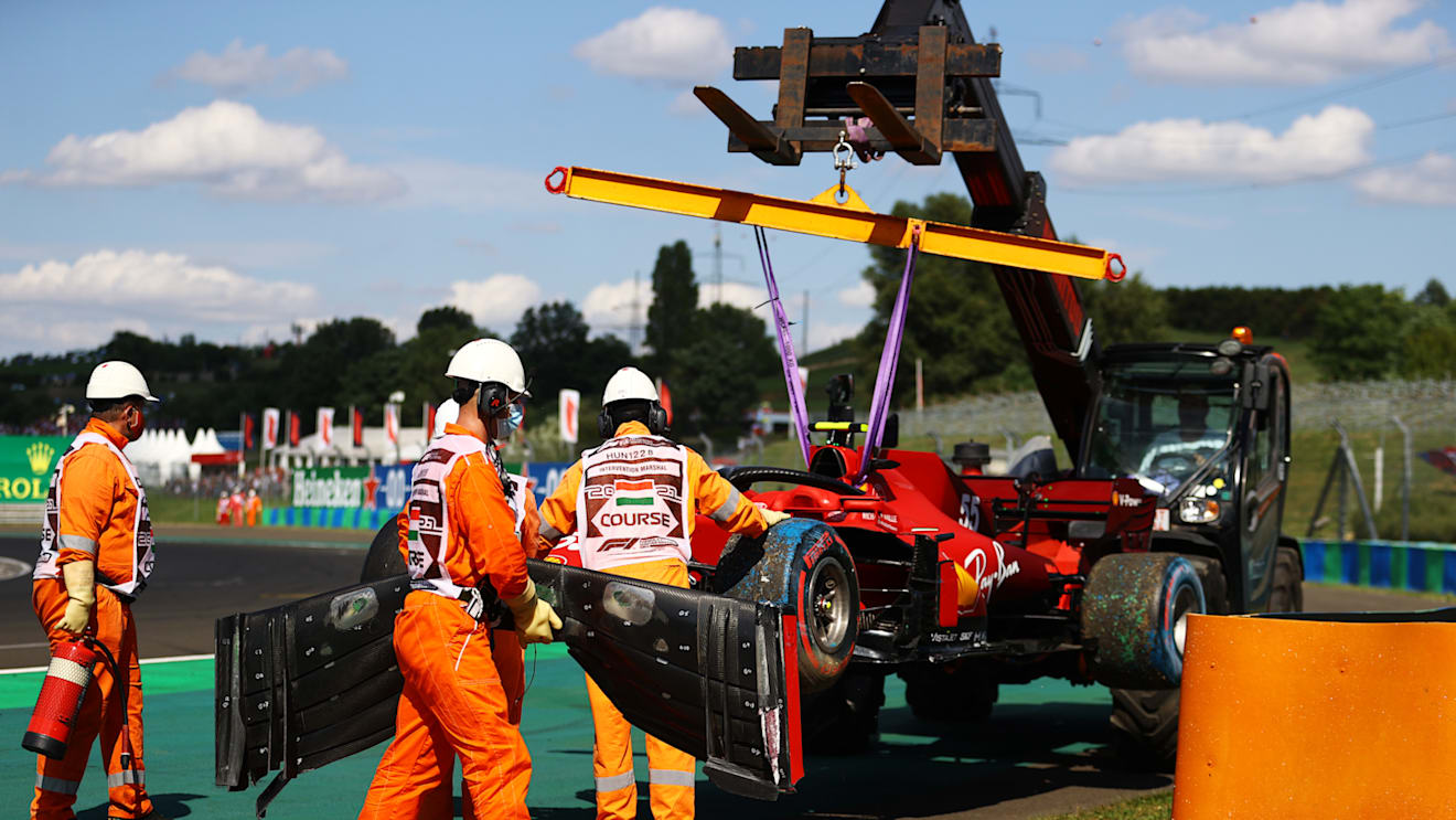 BUDAPEST, HUNGARY - JULY 31: The car of Carlos Sainz of Spain and Ferrari is removed from the track after a crash during qualifying ahead of the F1 Grand Prix of Hungary at Hungaroring on July 31, 2021 in Budapest, Hungary. (Photo by Bryn Lennon/Getty Images)