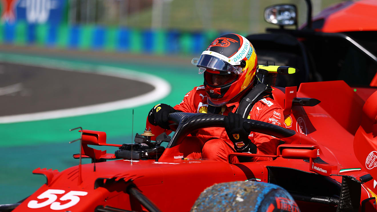 BUDAPEST, HUNGARY - JULY 31: Carlos Sainz of Spain driving the (55) Scuderia Ferrari SF21 climbs from his car after a crash during qualifying ahead of the F1 Grand Prix of Hungary at Hungaroring on July 31, 2021 in Budapest, Hungary. (Photo by Bryn Lennon/Getty Images)