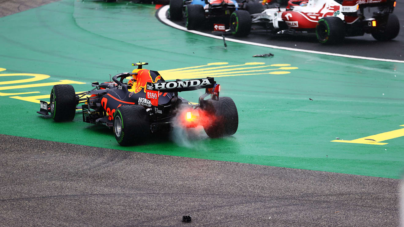 BUDAPEST, HUNGARY - AUGUST 01: Sergio Perez of Mexico driving the (11) Red Bull Racing RB16B Honda runs wide at the start as cars tangle ahead of him during the F1 Grand Prix of Hungary at Hungaroring on August 01, 2021 in Budapest, Hungary. (Photo by Bryn Lennon/Getty Images)