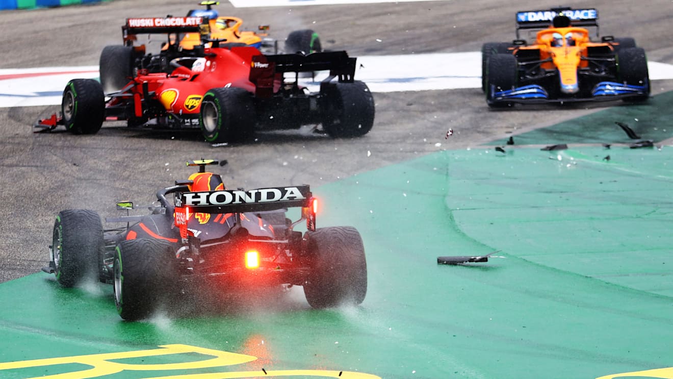 BUDAPEST, HUNGARY - AUGUST 01: Sergio Perez of Mexico driving the (11) Red Bull Racing RB16B Honda runs wide at the start as cars tangle ahead of him during the F1 Grand Prix of Hungary at Hungaroring on August 01, 2021 in Budapest, Hungary. (Photo by Bryn Lennon/Getty Images)