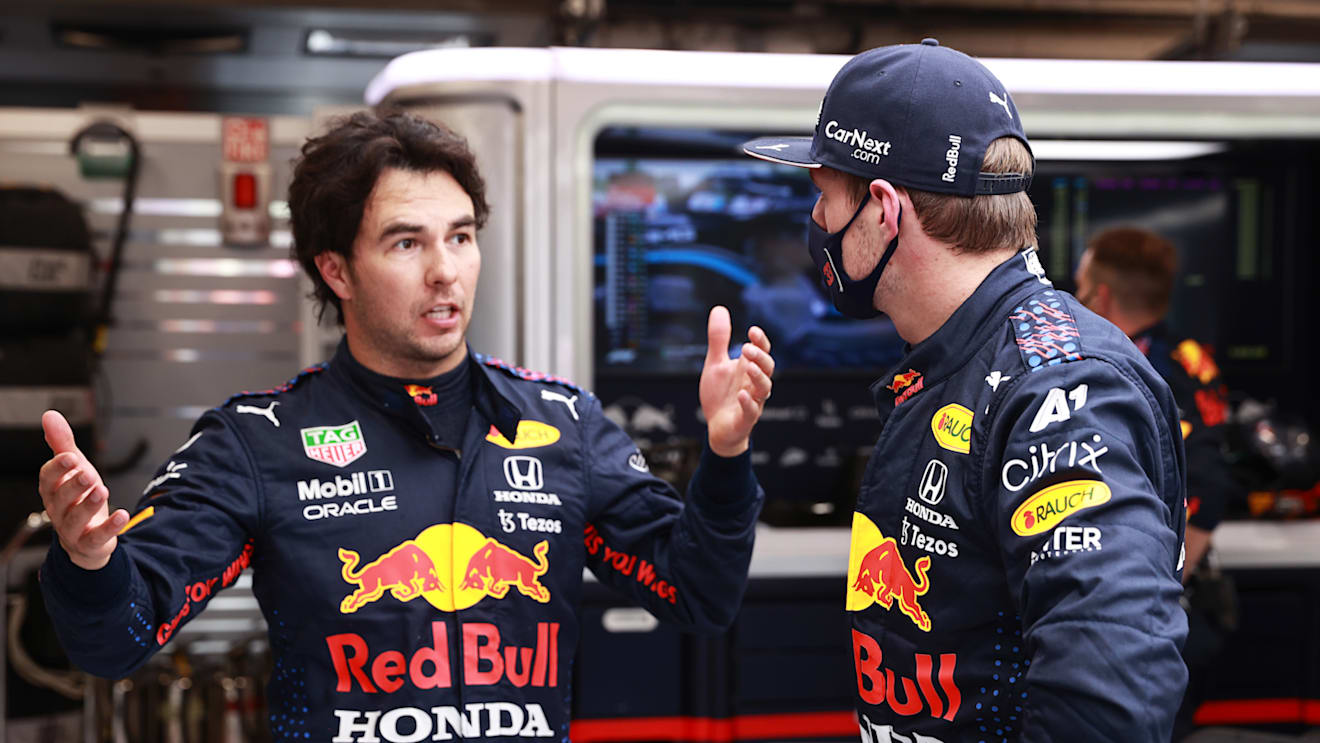 BUDAPEST, HUNGARY - AUGUST 01: Max Verstappen of Netherlands and Red Bull Racing and Sergio Perez of Mexico and Red Bull Racing talk in the garage during the red flag delay during the F1 Grand Prix of Hungary at Hungaroring on August 01, 2021 in Budapest, Hungary. (Photo by Mark Thompson/Getty Images)