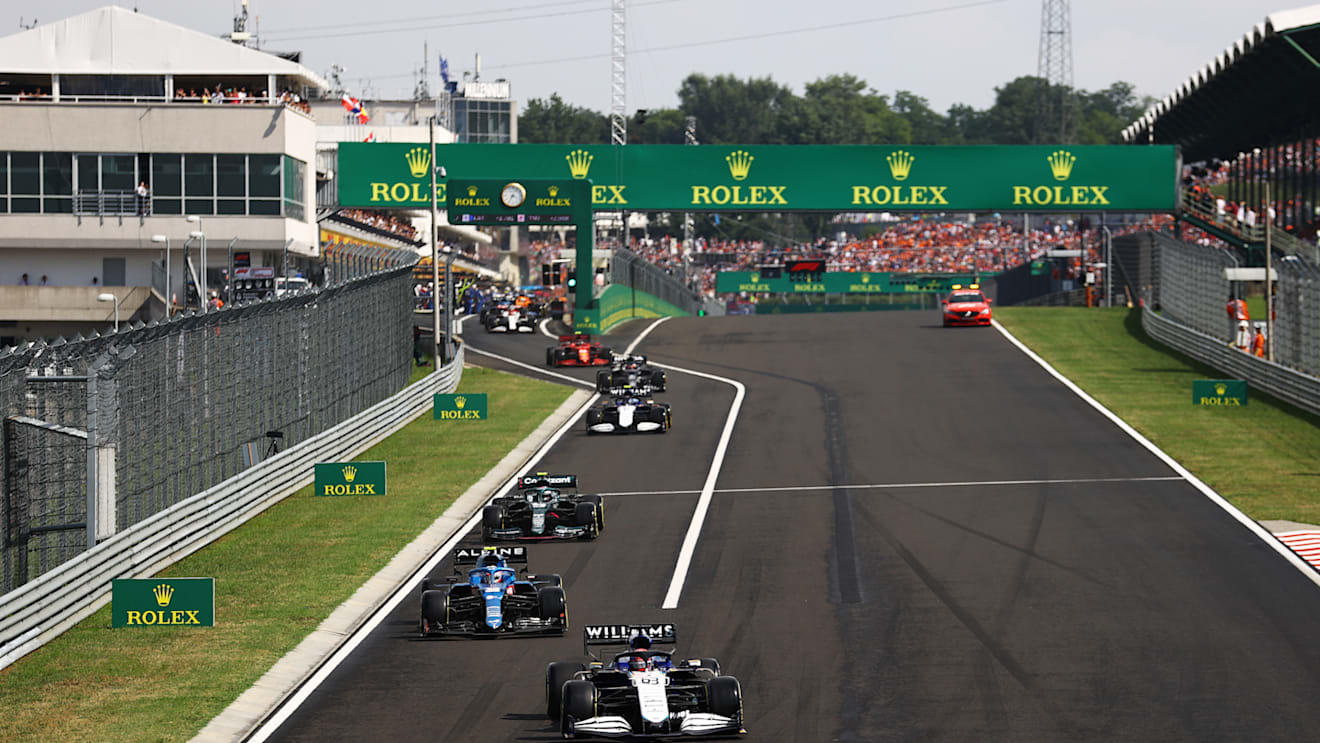 BUDAPEST, HUNGARY - AUGUST 01: George Russell of Great Britain driving the (63) Williams Racing FW43B Mercedes leads a line of cars out of the pitlane after pitting at the restart during the F1 Grand Prix of Hungary at Hungaroring on August 01, 2021 in Budapest, Hungary. (Photo by Bryn Lennon/Getty Images)