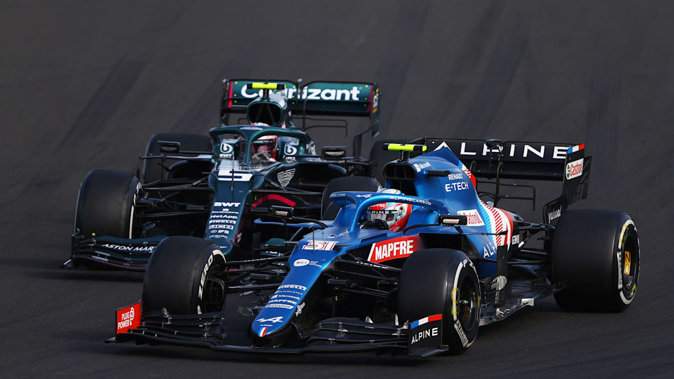 BUDAPEST, HUNGARY - AUGUST 01: Esteban Ocon of France driving the (31) Alpine A521 Renault leads Sebastian Vettel of Germany driving the (5) Aston Martin AMR21 Mercedes during the F1 Grand Prix of Hungary at Hungaroring on August 01, 2021 in Budapest, Hungary. (Photo by Bryn Lennon/Getty Images)