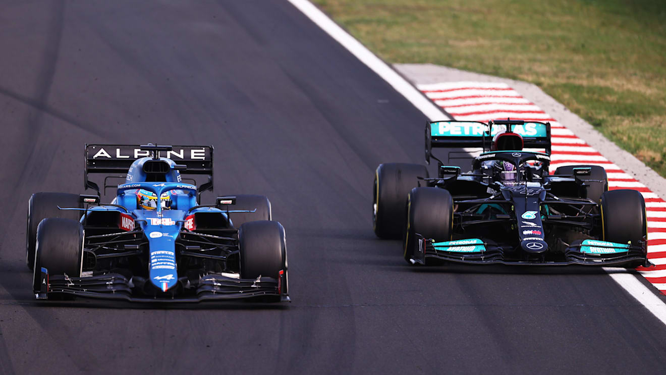 BUDAPEST, HUNGARY - AUGUST 01: Fernando Alonso of Spain driving the (14) Alpine A521 Renault defends from Lewis Hamilton of Great Britain driving the (44) Mercedes AMG Petronas F1 Team Mercedes W12 during the F1 Grand Prix of Hungary at Hungaroring on August 01, 2021 in Budapest, Hungary. (Photo by Lars Baron/Getty Images)