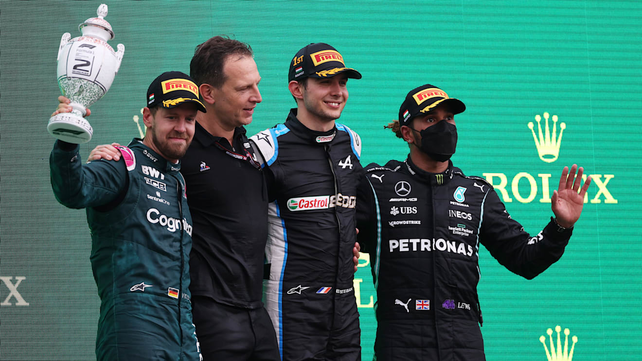 BUDAPEST, HUNGARY - AUGUST 01: Race winner Esteban Ocon of France and Alpine F1 Team, second placed Sebastian Vettel of Germany and Aston Martin F1 Team and third placed Lewis Hamilton of Great Britain and Mercedes GP celebrate on the podium during the F1 Grand Prix of Hungary at Hungaroring on August 01, 2021 in Budapest, Hungary. (Photo by Lars Baron/Getty Images)