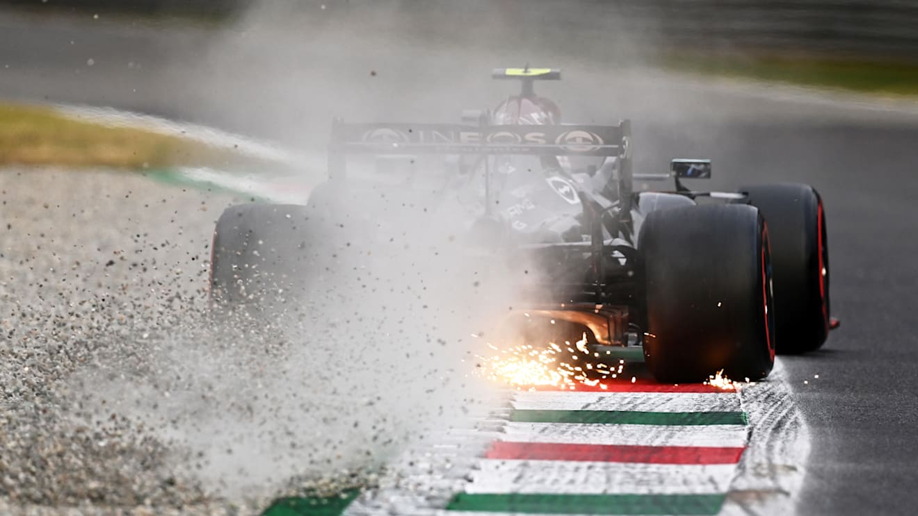 MONZA, ITALY - SEPTEMBER 10: Sparks and gravel fly behind Valtteri Bottas of Finland driving the (77) Mercedes AMG Petronas F1 Team Mercedes W12 during qualifying ahead of the F1 Grand Prix of Italy at Autodromo di Monza on September 10, 2021 in Monza, Italy. (Photo by Clive Mason - Formula 1/Formula 1 via Getty Images)