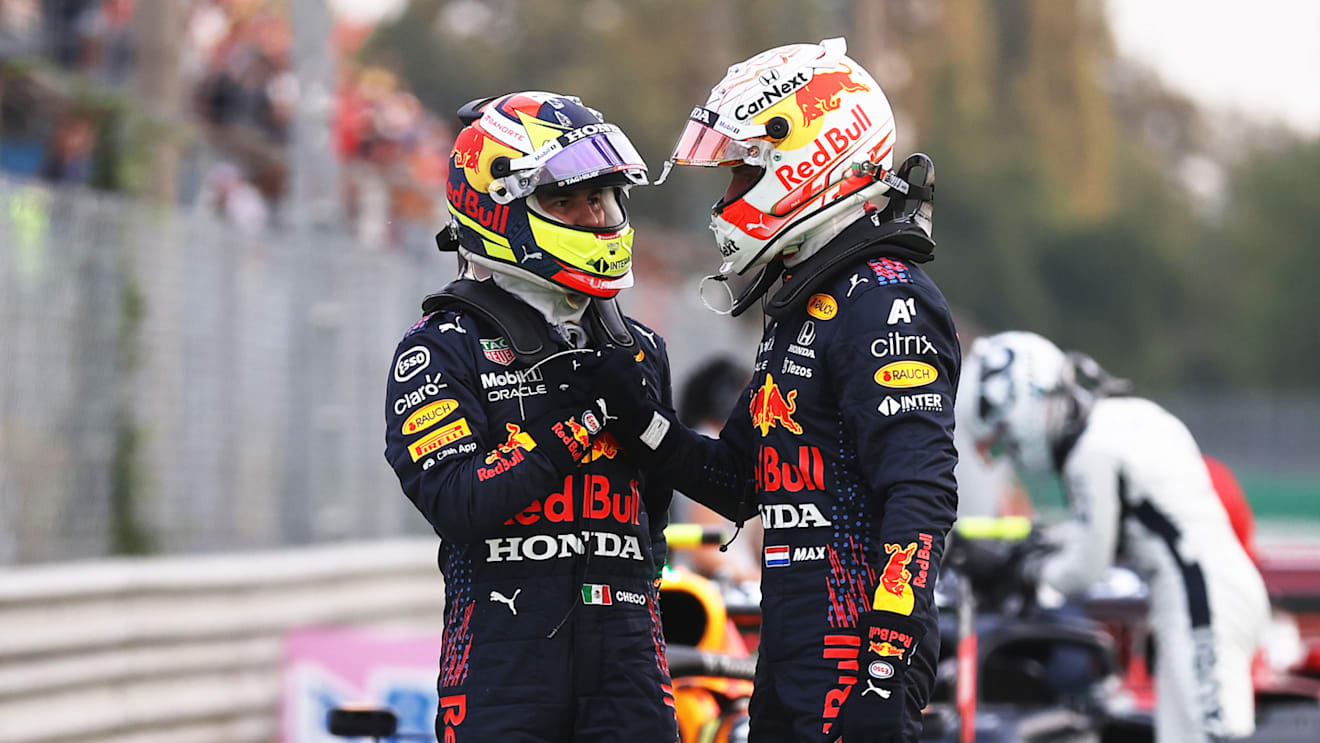 MONZA, ITALY - SEPTEMBER 10: Max Verstappen of Netherlands and Red Bull Racing and Sergio Perez of Mexico and Red Bull Racing talk in parc ferme during qualifying ahead of the F1 Grand Prix of Italy at Autodromo di Monza on September 10, 2021 in Monza, Italy. (Photo by Lars Baron/Getty Images)