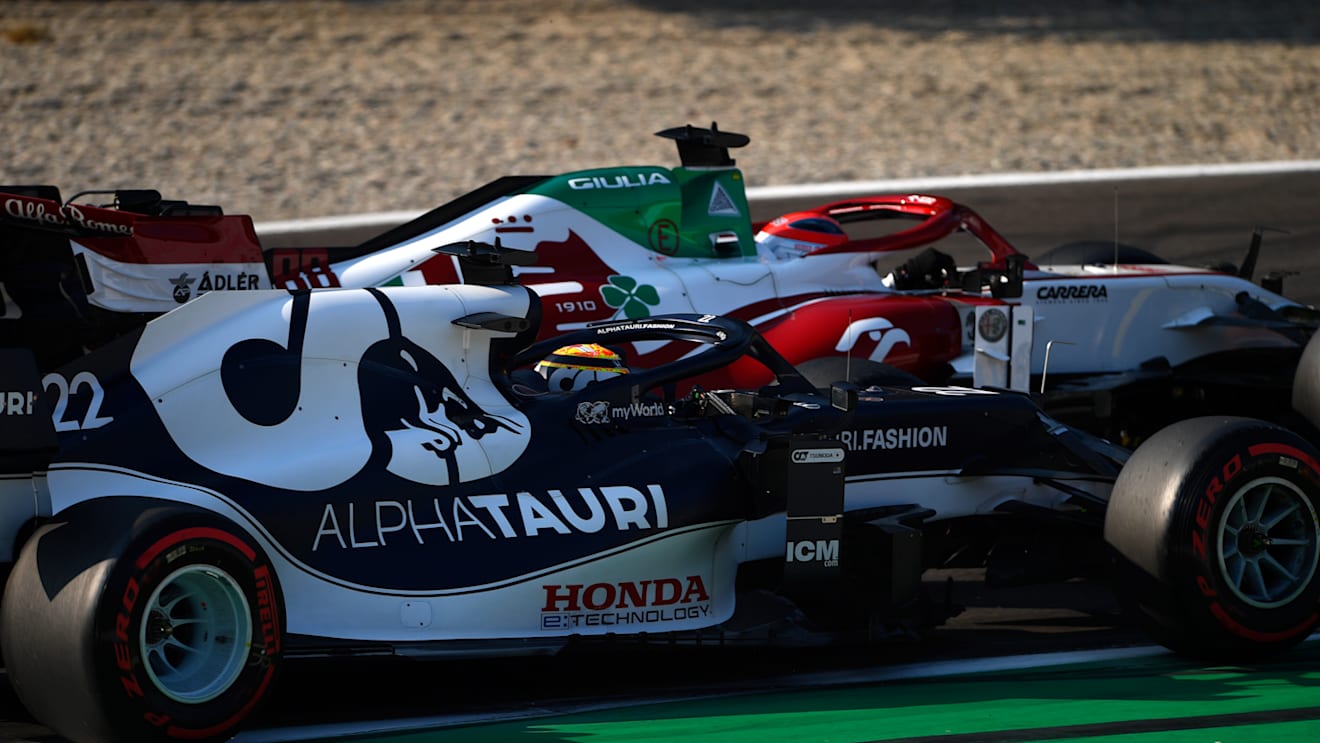 MONZA, ITALY - SEPTEMBER 11: Robert Kubica of Poland driving the (88) Alfa Romeo Racing C41 Ferrari and Yuki Tsunoda of Japan driving the (22) Scuderia AlphaTauri AT02 Honda battle for position during the Sprint ahead of the F1 Grand Prix of Italy at Autodromo di Monza on September 11, 2021 in Monza, Italy. (Photo by Rudy Carezzevoli/Getty Images)