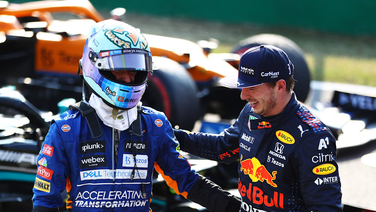 MONZA, ITALY - SEPTEMBER 11: Second place finisher Max Verstappen of Netherlands and Red Bull Racing talks with third place finisher Daniel Ricciardo of Australia and McLaren F1 in parc ferme during the Sprint ahead of the F1 Grand Prix of Italy at Autodromo di Monza on September 11, 2021 in Monza, Italy. (Photo by Bryn Lennon/Getty Images)