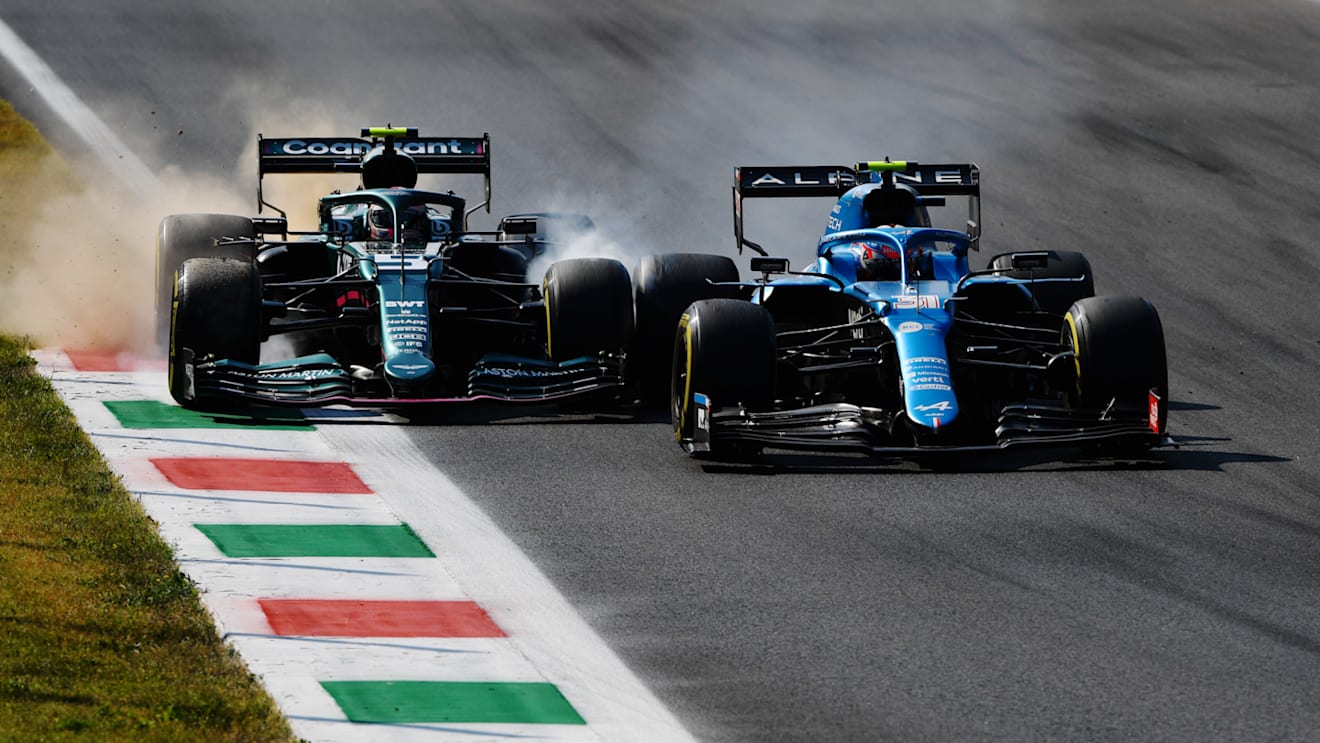 MONZA, ITALY - SEPTEMBER 12: Esteban Ocon of France driving the (31) Alpine A521 Renault and Sebastian Vettel of Germany driving the (5) Aston Martin AMR21 Mercedes collide during the F1 Grand Prix of Italy at Autodromo di Monza on September 12, 2021 in Monza, Italy. (Photo by Rudy Carezzevoli/Getty Images)