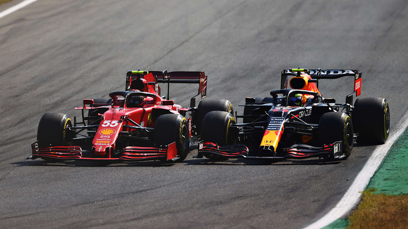 MONZA, ITALY - SEPTEMBER 12: Sergio Perez of Mexico driving the (11) Red Bull Racing RB16B Honda and Carlos Sainz of Spain driving the (55) Scuderia Ferrari SF21 during the F1 Grand Prix of Italy at Autodromo di Monza on September 12, 2021 in Monza, Italy. (Photo by Dan Istitene - Formula 1/Formula 1 via Getty Images)