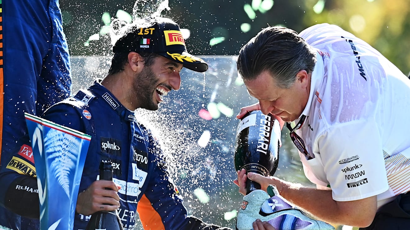 MONZA, ITALY - SEPTEMBER 12: Race winner Daniel Ricciardo of Australia and McLaren F1 and McLaren Chief Executive Officer Zak Brown celebrate on the podium during the F1 Grand Prix of Italy at Autodromo di Monza on September 12, 2021 in Monza, Italy. (Photo by Clive Mason - Formula 1/Formula 1 via Getty Images)