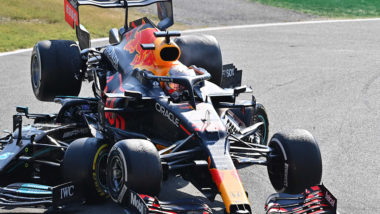 MONZA, ITALY - SEPTEMBER 12: Max Verstappen of the Netherlands driving the (33) Red Bull Racing RB16B Honda and Lewis Hamilton of Great Britain driving the (44) Mercedes AMG Petronas F1 Team Mercedes W12 crash during the F1 Grand Prix of Italy at Autodromo di Monza on September 12, 2021 in Monza, Italy. (Photo by Peter Van Egmond/Getty Images)