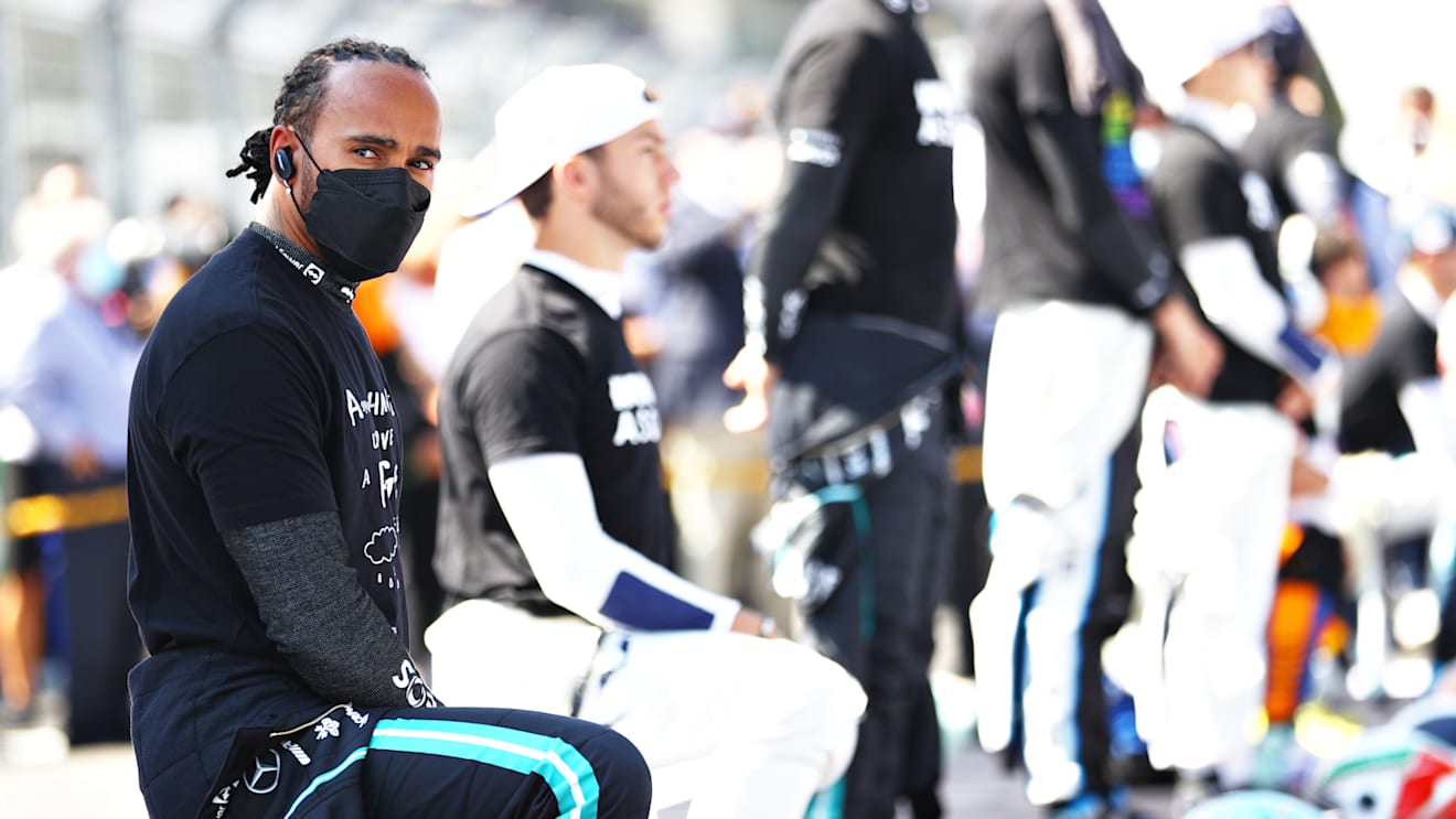 MEXICO CITY, MEXICO - NOVEMBER 07: Lewis Hamilton of Great Britain and Mercedes GP takes a knee on the grid as part of the We Race As One gesture before the F1 Grand Prix of Mexico at Autodromo Hermanos Rodriguez on November 07, 2021 in Mexico City, Mexico. (Photo by Bryn Lennon - Formula 1/Formula 1 via Getty Images)
