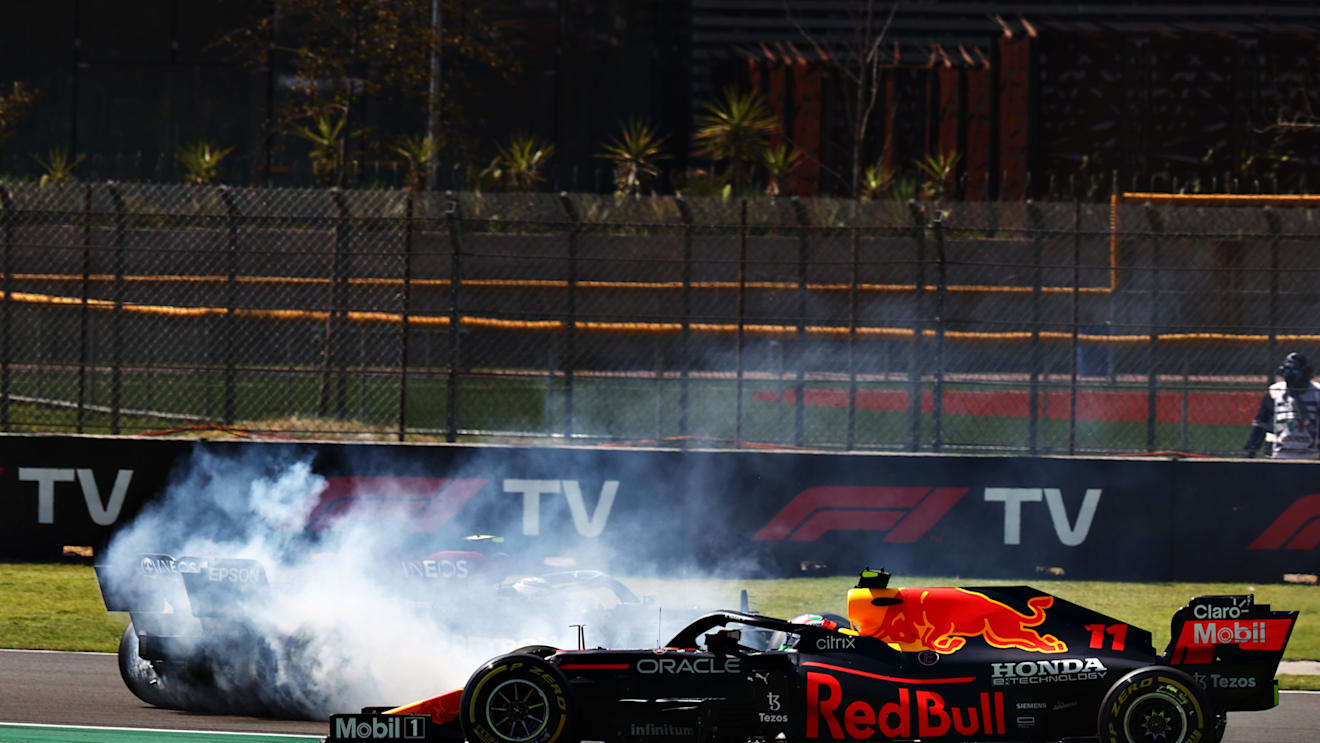MEXICO CITY, MEXICO - NOVEMBER 07: Sergio Perez of Mexico driving the (11) Red Bull Racing RB16B Honda passes Valtteri Bottas of Finland driving the (77) Mercedes AMG Petronas F1 Team Mercedes W12 as he spins during the F1 Grand Prix of Mexico at Autodromo Hermanos Rodriguez on November 07, 2021 in Mexico City, Mexico. (Photo by Mark Thompson/Getty Images)
