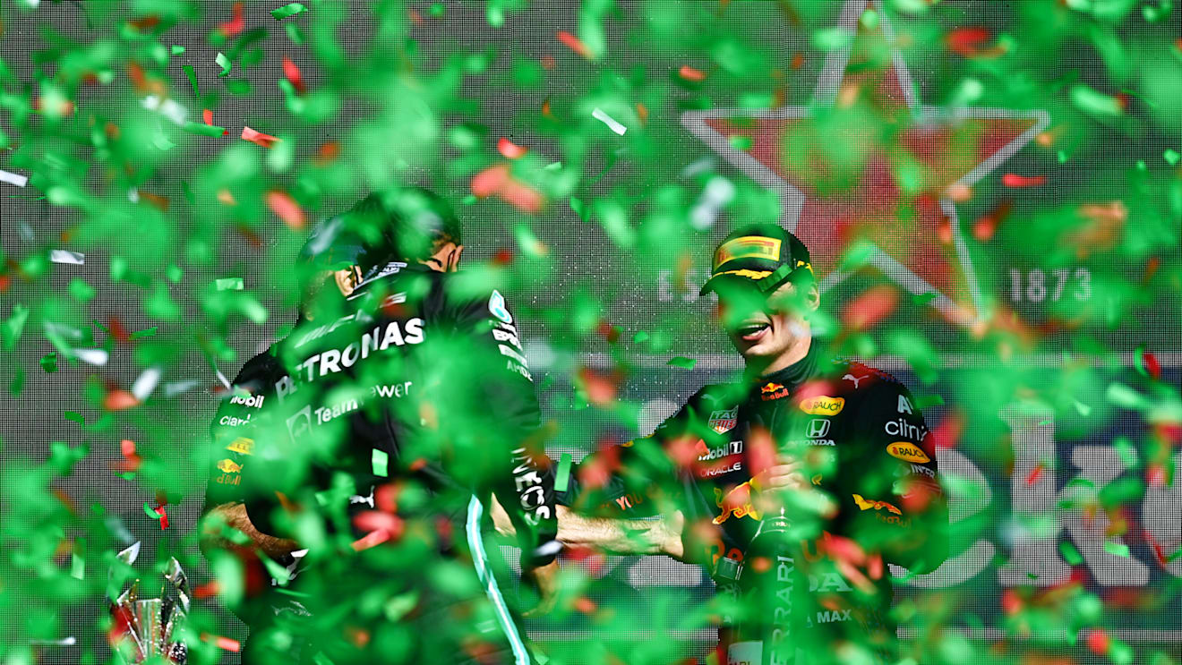 MEXICO CITY, MEXICO - NOVEMBER 07: Second placed Lewis Hamilton of Great Britain and Mercedes GP and third placed Sergio Perez of Mexico and Red Bull Racing celebrate on the podium during the F1 Grand Prix of Mexico at Autodromo Hermanos Rodriguez on November 07, 2021 in Mexico City, Mexico. (Photo by Clive Mason/Getty Images)