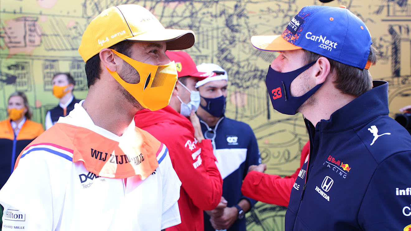 ZANDVOORT, NETHERLANDS - SEPTEMBER 05: Max Verstappen of Netherlands and Red Bull Racing and Daniel Ricciardo of Australia and McLaren F1 talk on the drivers parade ahead of the F1 Grand Prix of The Netherlands at Circuit Zandvoort on September 05, 2021 in Zandvoort, Netherlands. (Photo by Peter Fox/Getty Images)