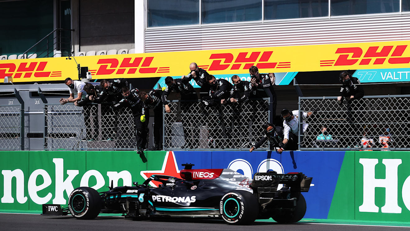 PORTIMAO, PORTUGAL - MAY 02: Mercedes GP team members celebrate on the pitwall as Lewis Hamilton of Great Britain driving the (44) Mercedes AMG Petronas F1 Team Mercedes W12 crosses the finish line to win during the F1 Grand Prix of Portugal at Autodromo Internacional Do Algarve on May 02, 2021 in Portimao, Portugal. (Photo by Lars Baron/Getty Images)