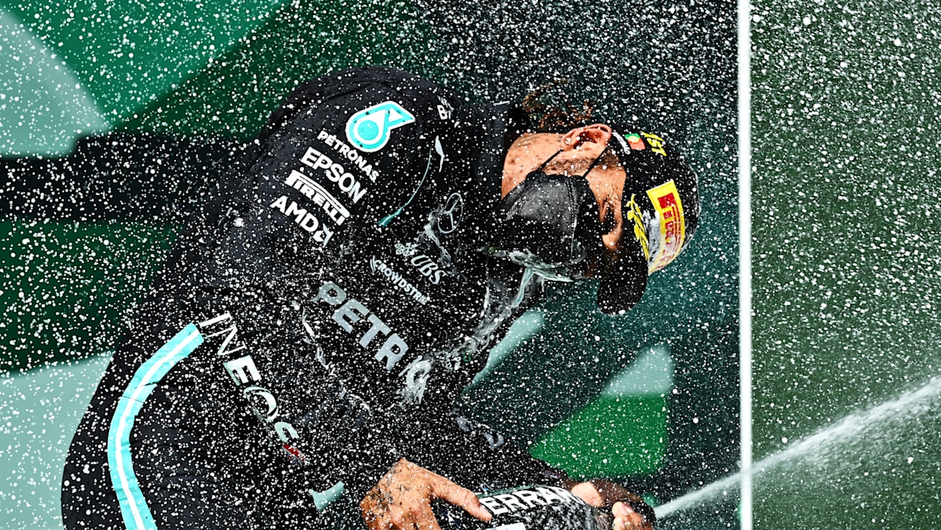 PORTIMAO, PORTUGAL - MAY 02: Race winner Lewis Hamilton of Great Britain and Mercedes GP celebrates with sparkling wine on the podium during the F1 Grand Prix of Portugal at Autodromo Internacional Do Algarve on May 02, 2021 in Portimao, Portugal. (Photo by Clive Mason - Formula 1/Formula 1 via Getty Images)