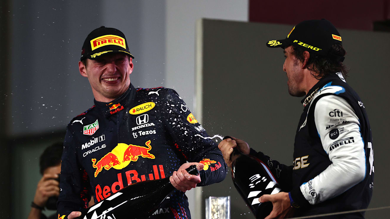 DOHA, QATAR - NOVEMBER 21: Second placed Max Verstappen of Netherlands and Red Bull Racing and Third placed Fernando Alonso of Spain and Alpine F1 Team celebrate on the podium during the F1 Grand Prix of Qatar at Losail International Circuit on November 21, 2021 in Doha, Qatar. (Photo by Mark Thompson/Getty Images)