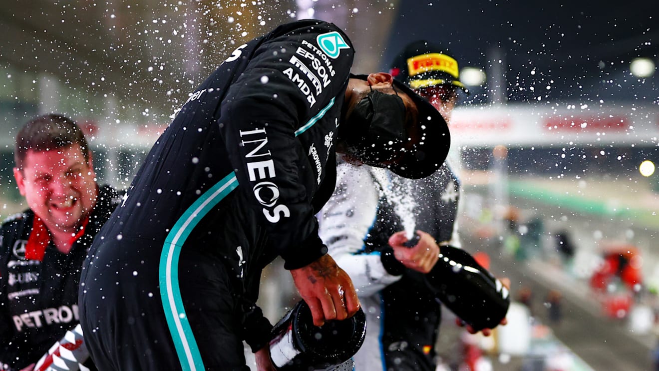 DOHA, QATAR - NOVEMBER 21: Race winner Lewis Hamilton of Great Britain and Mercedes GP, Second placed Max Verstappen of Netherlands and Red Bull Racing and Third placed Fernando Alonso of Spain and Alpine F1 Team celebrate on the podium during the F1 Grand Prix of Qatar at Losail International Circuit on November 21, 2021 in Doha, Qatar. (Photo by Dan Istitene - Formula 1/Formula 1 via Getty Images)