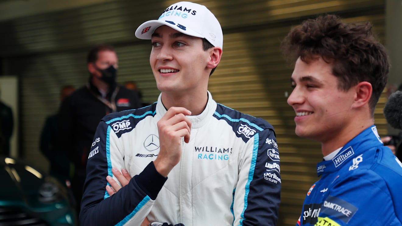 SOCHI, RUSSIA - SEPTEMBER 25: Pole position qualifier Lando Norris of Great Britain and McLaren F1 talks with third place qualifier George Russell of Great Britain and Williams in parc ferme during qualifying ahead of the F1 Grand Prix of Russia at Sochi Autodrom on September 25, 2021 in Sochi, Russia. (Photo by Yuri Kochetkov - Pool/Getty Images)