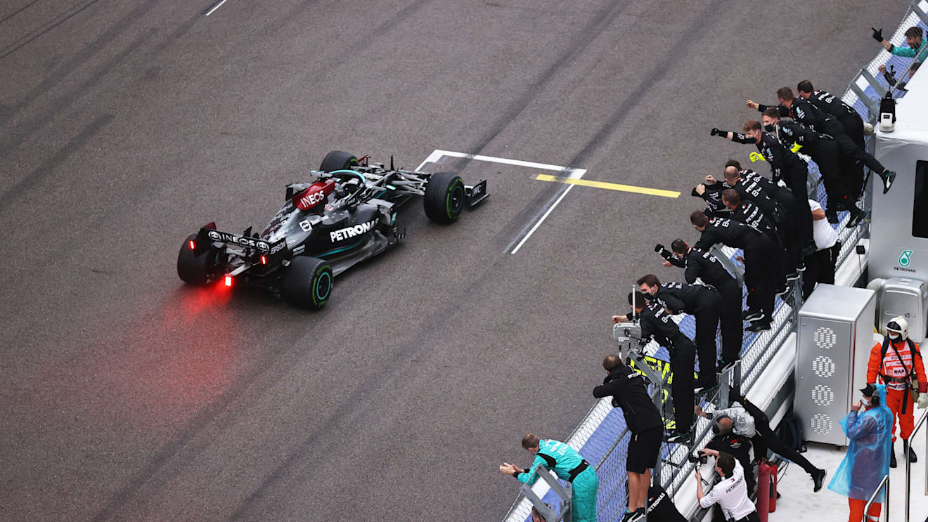 SOCHI, RUSSIA - SEPTEMBER 26: Race winner Lewis Hamilton of Great Britain driving the (44) Mercedes AMG Petronas F1 Team Mercedes W12 passes his team celebrating on the pitwall during the F1 Grand Prix of Russia at Sochi Autodrom on September 26, 2021 in Sochi, Russia. (Photo by Lars Baron - Formula 1/Formula 1 via Getty Images)
