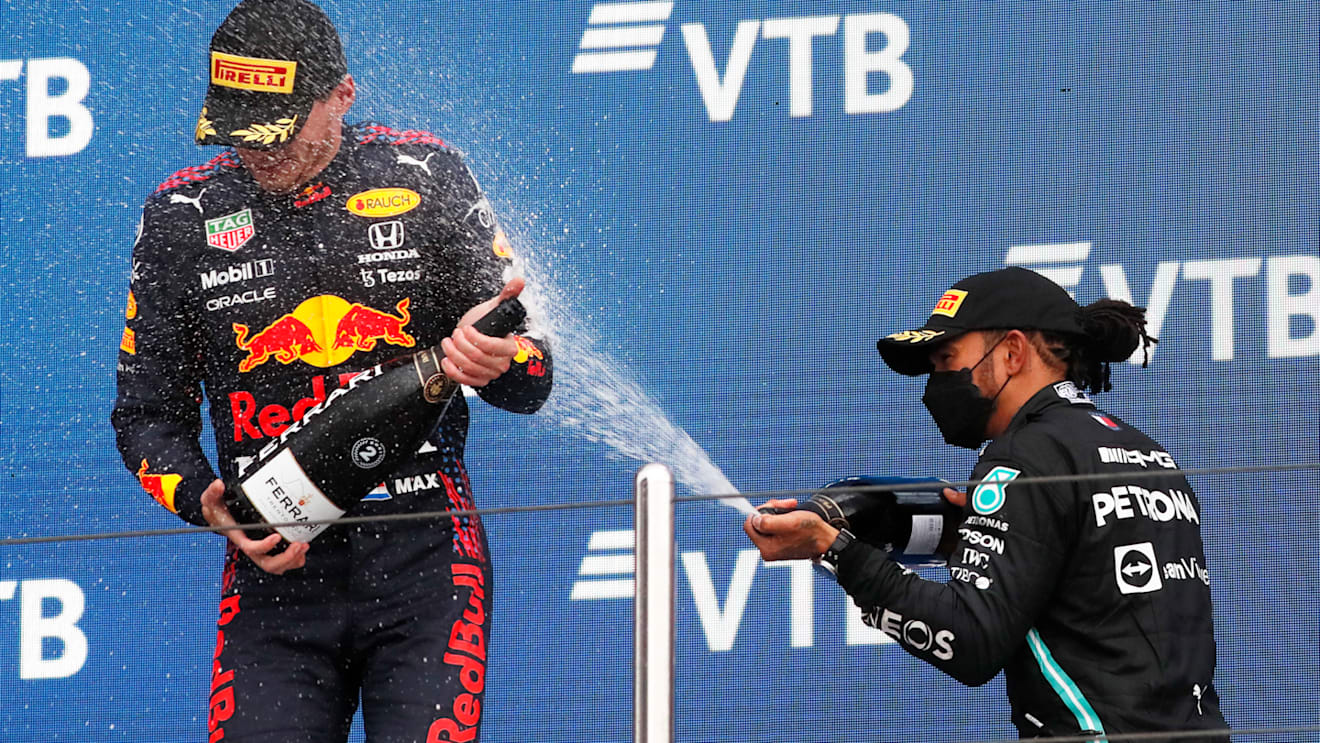 SOCHI, RUSSIA - SEPTEMBER 26: Race winner Lewis Hamilton of Great Britain and Mercedes GP celebrates on the podium with second placed Max Verstappen of Netherlands and Red Bull Racing during the F1 Grand Prix of Russia at Sochi Autodrom on September 26, 2021 in Sochi, Russia. (Photo by Yuri Kochetkov - Pool/Getty Images)