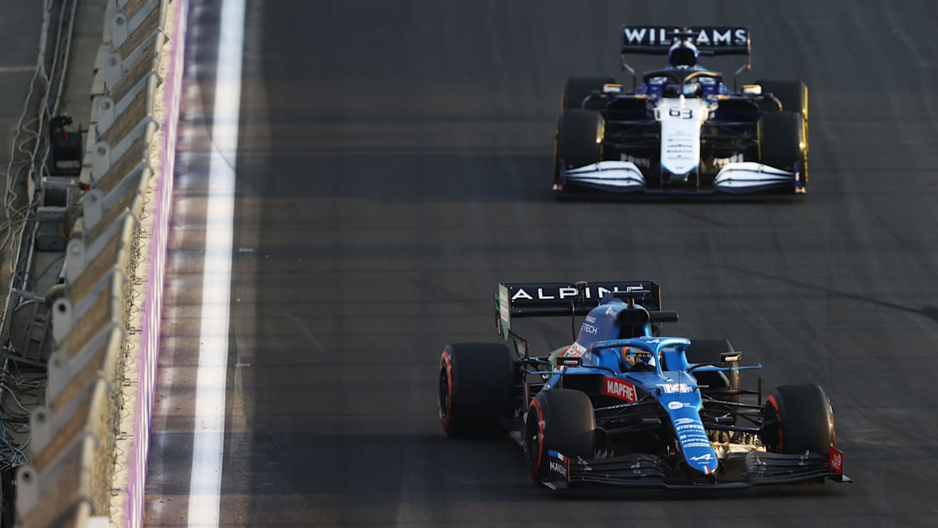 JEDDAH, SAUDI ARABIA - DECEMBER 03: Fernando Alonso of Spain driving the (14) Alpine A521 Renault leads George Russell of Great Britain driving the (63) Williams Racing FW43B Mercedes during practice ahead of the F1 Grand Prix of Saudi Arabia at Jeddah Corniche Circuit on December 03, 2021 in Jeddah, Saudi Arabia. (Photo by Bryn Lennon - Formula 1/Formula 1 via Getty Images)
