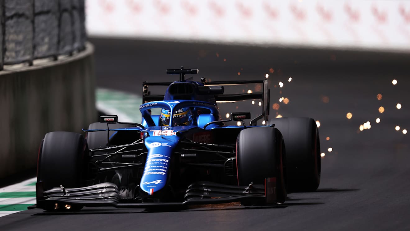 JEDDAH, SAUDI ARABIA - DECEMBER 03: Sparks fly behind Fernando Alonso of Spain driving the (14) Alpine A521 Renault during practice ahead of the F1 Grand Prix of Saudi Arabia at Jeddah Corniche Circuit on December 03, 2021 in Jeddah, Saudi Arabia. (Photo by Lars Baron/Getty Images)
