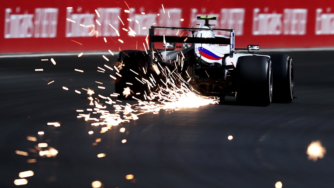 JEDDAH, SAUDI ARABIA - DECEMBER 03: Sparks fly behind Mick Schumacher of Germany driving the (47) Haas F1 Team VF-21 Ferrari during practice ahead of the F1 Grand Prix of Saudi Arabia at Jeddah Corniche Circuit on December 03, 2021 in Jeddah, Saudi Arabia. (Photo by Lars Baron/Getty Images)