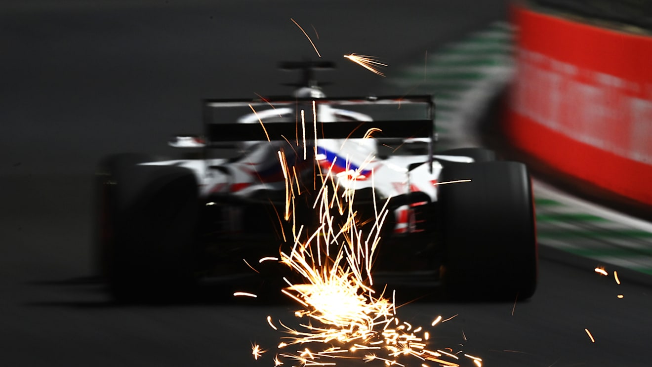 JEDDAH, SAUDI ARABIA - DECEMBER 04: Sparks fly behind Nikita Mazepin of Russia driving the (9) Haas F1 Team VF-21 Ferrari during final practice ahead of the F1 Grand Prix of Saudi Arabia at Jeddah Corniche Circuit on December 04, 2021 in Jeddah, Saudi Arabia. (Photo by Dan Mullan/Getty Images)
