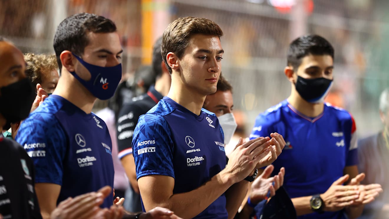 JEDDAH, SAUDI ARABIA - DECEMBER 05: Nicholas Latifi of Canada and Williams and George Russell of Great Britain and Williams pay tribute to the late Sir Frank Williams with the rest of the F1 community ahead of the F1 Grand Prix of Saudi Arabia at Jeddah Corniche Circuit on December 05, 2021 in Jeddah, Saudi Arabia. (Photo by Bryn Lennon - Formula 1/Formula 1 via Getty Images)