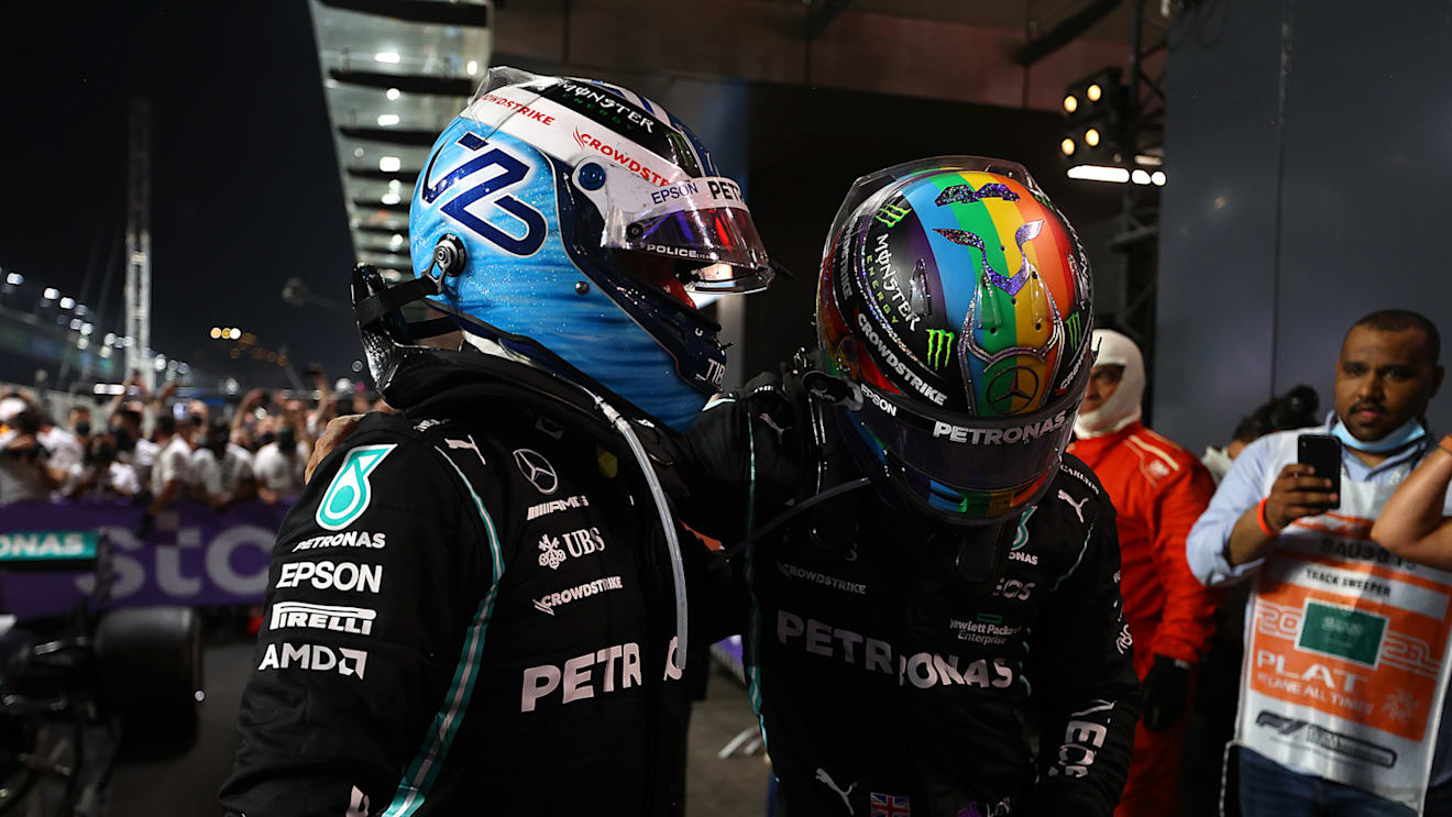 JEDDAH, SAUDI ARABIA - DECEMBER 05: Race winner Lewis Hamilton of Great Britain and Mercedes GP and third placed Valtteri Bottas of Finland and Mercedes GP celebrate in parc ferme during the F1 Grand Prix of Saudi Arabia at Jeddah Corniche Circuit on December 05, 2021 in Jeddah, Saudi Arabia. (Photo by Bryn Lennon - Formula 1/Formula 1 via Getty Images)