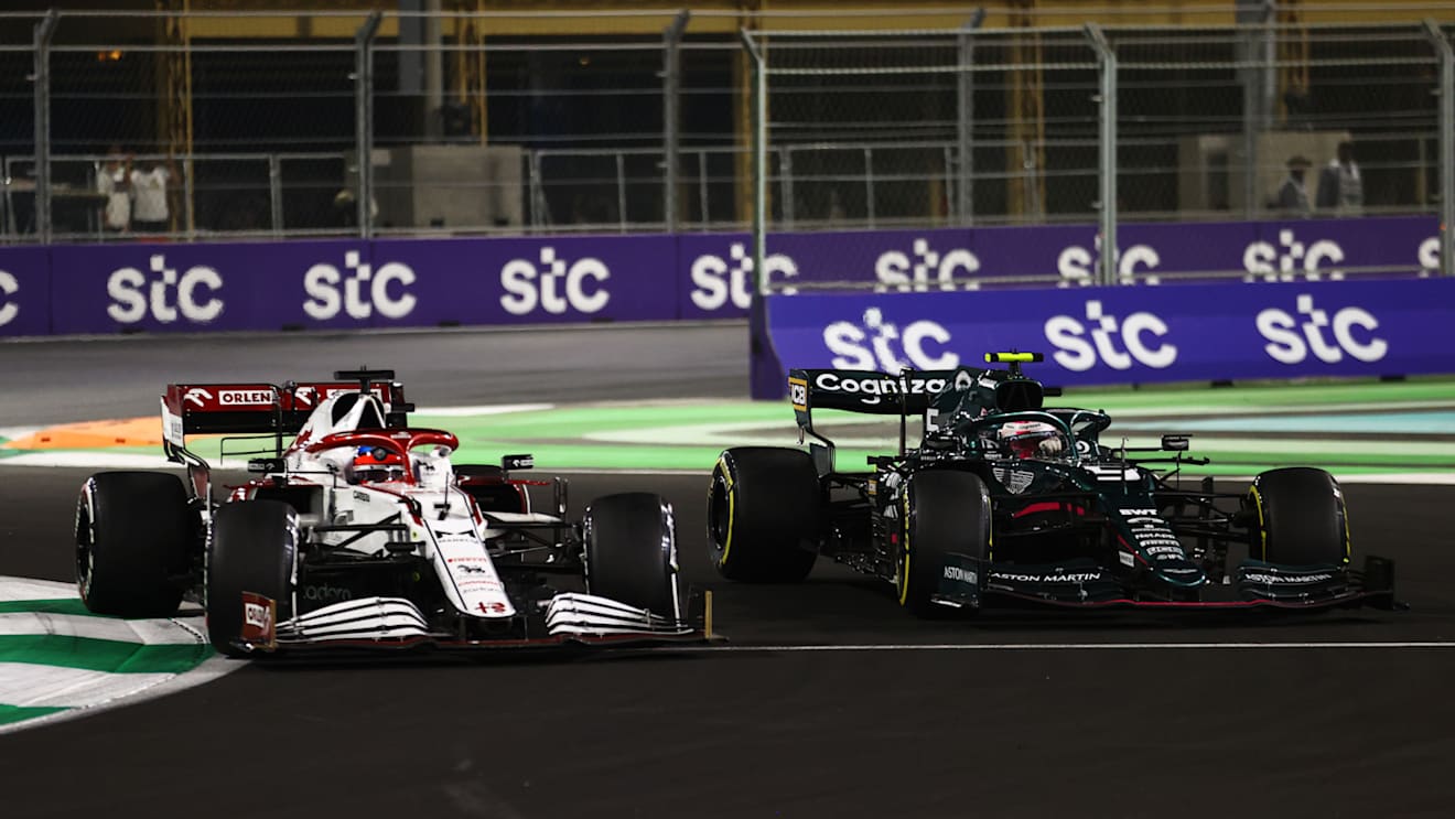 JEDDAH, SAUDI ARABIA - DECEMBER 05: Kimi Raikkonen of Finland driving the (7) Alfa Romeo Racing C41 Ferrari and Sebastian Vettel of Germany driving the (5) Aston Martin AMR21 Mercedes  during the F1 Grand Prix of Saudi Arabia at Jeddah Corniche Circuit on December 05, 2021 in Jeddah, Saudi Arabia. (Photo by Bryn Lennon - Formula 1/Formula 1 via Getty Images)