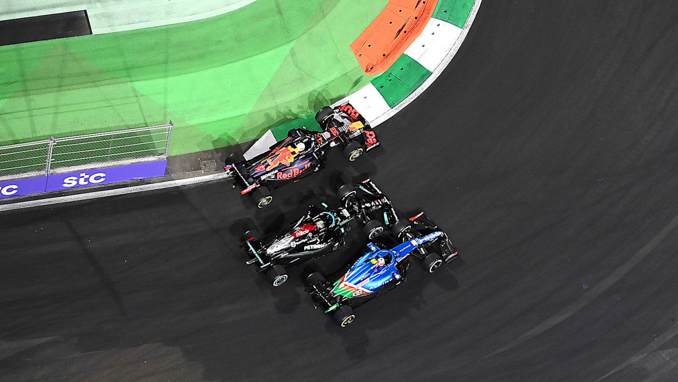 JEDDAH, SAUDI ARABIA - DECEMBER 05: Esteban Ocon of France driving the (31) Alpine A521 Renault, Lewis Hamilton of Great Britain driving the (44) Mercedes AMG Petronas F1 Team Mercedes W12 and Max Verstappen of the Netherlands driving the (33) Red Bull Racing RB16B Honda battle for track position at the second restart during the F1 Grand Prix of Saudi Arabia at Jeddah Corniche Circuit on December 05, 2021 in Jeddah, Saudi Arabia. (Photo by Dan Mullan/Getty Images)