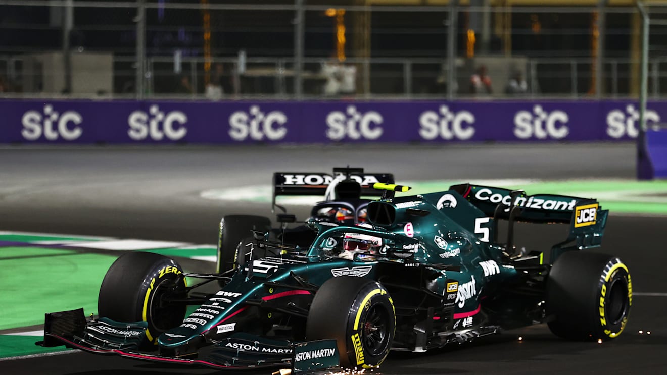 JEDDAH, SAUDI ARABIA - DECEMBER 05: Sebastian Vettel of Germany driving the (5) Aston Martin AMR21 Mercedes and Yuki Tsunoda of Japan driving the (22) Scuderia AlphaTauri AT02 Honda collide during the F1 Grand Prix of Saudi Arabia at Jeddah Corniche Circuit on December 05, 2021 in Jeddah, Saudi Arabia. (Photo by Bryn Lennon - Formula 1/Formula 1 via Getty Images)