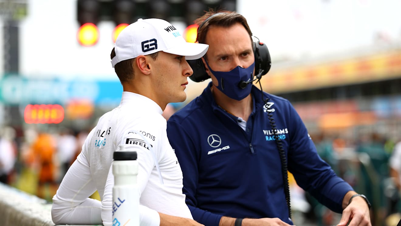 BARCELONA, SPAIN - MAY 09: George Russell of Great Britain and Williams prepares to drive on the grid with a team member prior to the F1 Grand Prix of Spain at Circuit de Barcelona-Catalunya on May 09, 2021 in Barcelona, Spain. (Photo by Bryn Lennon/Getty Images)