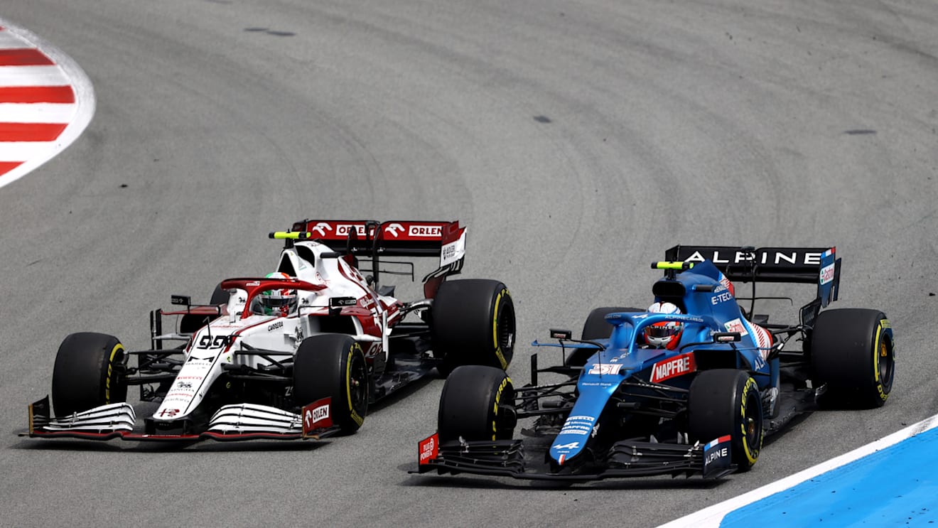 BARCELONA, SPAIN - MAY 09: Esteban Ocon of France driving the (31) Alpine A521 Renault and Antonio Giovinazzi of Italy driving the (99) Alfa Romeo Racing C41 Ferrari compete for position on track during the F1 Grand Prix of Spain at Circuit de Barcelona-Catalunya on May 09, 2021 in Barcelona, Spain. (Photo by Bryn Lennon/Getty Images)