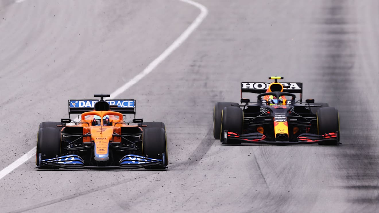 BARCELONA, SPAIN - MAY 09: Daniel Ricciardo of Australia driving the (3) McLaren F1 Team MCL35M Mercedes and Sergio Perez of Mexico driving the (11) Red Bull Racing RB16B Honda on track during the F1 Grand Prix of Spain at Circuit de Barcelona-Catalunya on May 09, 2021 in Barcelona, Spain. (Photo by Lars Baron/Getty Images)