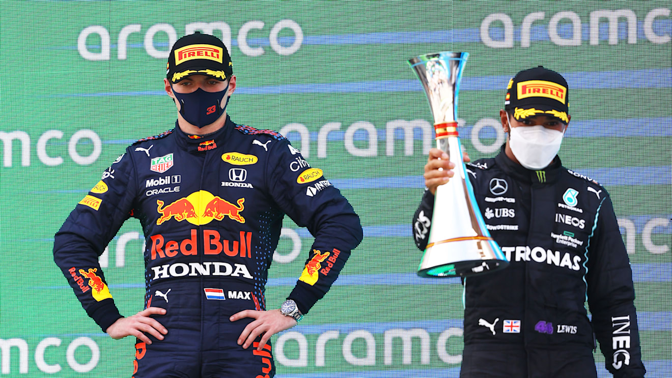 BARCELONA, SPAIN - MAY 09: Race winner Lewis Hamilton of Great Britain and Mercedes GP and second placed Max Verstappen of Netherlands and Red Bull Racing celebrate with sparkling wine on the podium during the F1 Grand Prix of Spain at Circuit de Barcelona-Catalunya on May 09, 2021 in Barcelona, Spain. (Photo by Bryn Lennon/Getty Images)