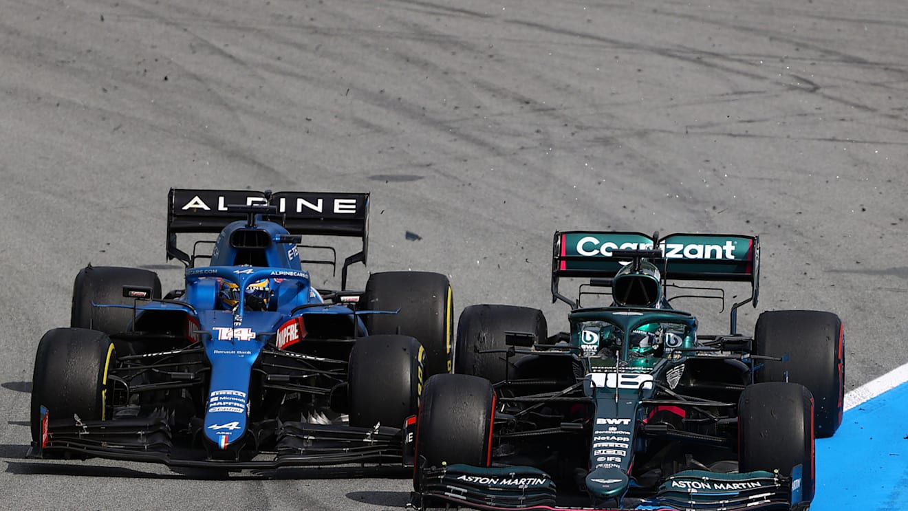 BARCELONA, SPAIN - MAY 09: Lance Stroll of Canada driving the (18) Aston Martin AMR21 Mercedes and Fernando Alonso of Spain driving the (14) Alpine A521 Renault battle for position during the F1 Grand Prix of Spain at Circuit de Barcelona-Catalunya on May 09, 2021 in Barcelona, Spain. (Photo by Bryn Lennon/Getty Images)