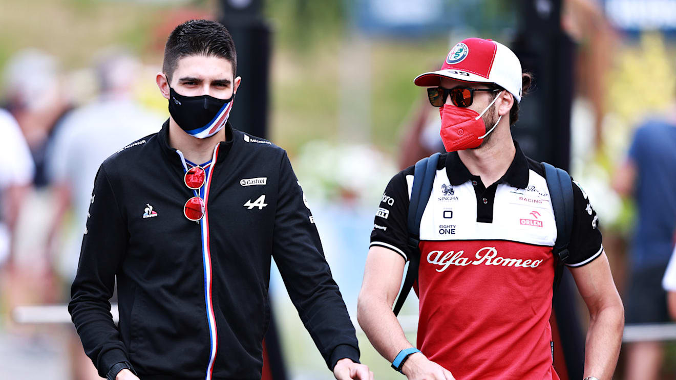 SPIELBERG, AUSTRIA - JUNE 25: Esteban Ocon of France and Alpine F1 Team and Antonio Giovinazzi of Italy and Alfa Romeo Racing talk in the Paddock before practice ahead of the F1 Grand Prix of Styria at Red Bull Ring on June 25, 2021 in Spielberg, Austria. (Photo by Mark Thompson/Getty Images)
